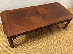 A long low coffee table with carved corner supports (132cm x 58cm)