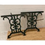 Two wrought iron green painted garden table legs