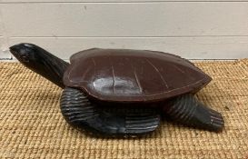 A wooden carving of a turtle