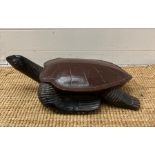 A wooden carving of a turtle