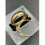A 9ct gold wedding band and a 9ct white three stone ring. (Approximate Total weight 3.9g) Size S and