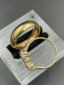 A 9ct gold wedding band and a 9ct white three stone ring. (Approximate Total weight 3.9g) Size S and