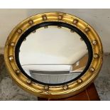 A Regency convex gilt wood wall mirror