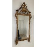 An 19th Century carved gilt mirror with urn of flowers and full scroll Approx 163cm x 75cm