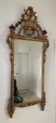 An 19th Century carved gilt mirror with urn of flowers and full scroll Approx 163cm x 75cm