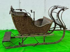 A wooden and woven original sledge carriage (H125cm W220cm D140cm)