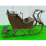 A wooden and woven original sledge carriage (H125cm W220cm D140cm)