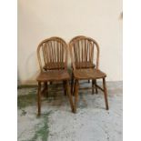 A set of four oak spindle back dining chairs