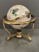 A rotating cradle globe of Gemstone and Lapis