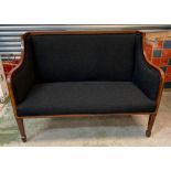 A two seater Edwardian sofa with mahogany inlaid frame, upholstered in black