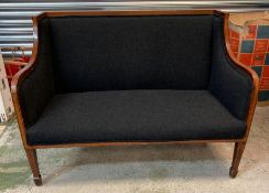 A two seater Edwardian sofa with mahogany inlaid frame, upholstered in black