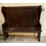 A stained pine Art and Craft style bench or settle