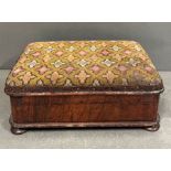 A mahogany Victorian footstool with needle point on bun feet opening to storage