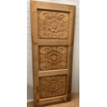 A wooden carved panel decorated with Tudor rose style flowers