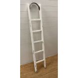 A white painted distressed vintage ladder