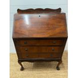 A mahogany bureau, the fall front enclosing a fitted interior above three long drawers (H100cm W75cm