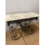 A French marble top garden table on an ornate cast iron base (H80cm W136cm D60cm)