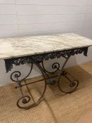 A French marble top garden table on an ornate cast iron base (H80cm W136cm D60cm)