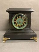A slate clock on gilt feet by Connell of London