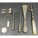 A selection of silver curios, to include button hook, shoehorn , key ring, salts spoons etc