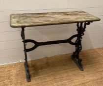 A reclaimed cast iron garden table with wooden top