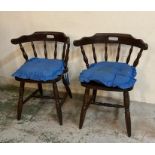 A pair of bow back Windsor chairs on turned legs and stretchers