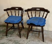A pair of bow back Windsor chairs on turned legs and stretchers