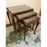 A nest of three mahogany glass top tables