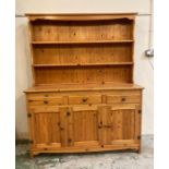 A pine three drawer, three cupboard Welsh dresser (H167cm W132cm D46cm)