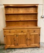 A pine three drawer, three cupboard Welsh dresser (H167cm W132cm D46cm)