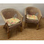 Two wicker arm chairs