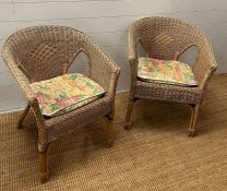 Two wicker arm chairs