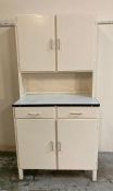 A white painted Mid Century kitchen unit with metal work top, two drawers and two cupboards over and