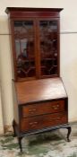 A glazed bureau bookcase