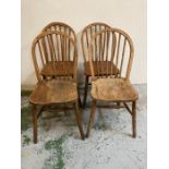 A set of four oak spindle back dining chairs