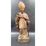 A wooden carved statue of Saint Blaise the bishop of Sebask, possibly 14th Century