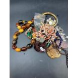 A selection of amber, jade and coral and some costume jewellery