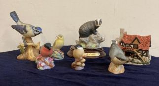 A selection of ceramics to include Royal Worcester birds, Badger by Leonardo and The Bothy by