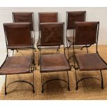 Six wrought iron folding chairs, sling style leather seat and seat back, aged brown leather with