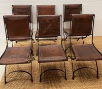 Six wrought iron folding chairs, sling style leather seat and seat back, aged brown leather with