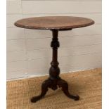 A burr walnut oval pedestal side table on tripod legs