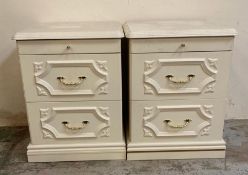 A pair of white bedside tables with brass effect handles