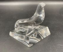 A Baccarat crystal seal on a rock.