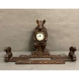 A Black Forest wood clock and a pair of adjustable bookends.
