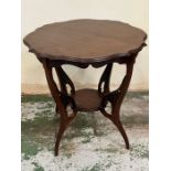 A scrolled Edwardian window table shaped top mounted on out curved legs and feet which are jointed
