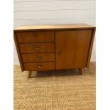 A Mid Century side cabinet, twin drawers to one side and cupboard to other, by Musterring Mobel