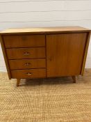 A Mid Century side cabinet, twin drawers to one side and cupboard to other, by Musterring Mobel