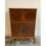 A Mid Century drinks cabinet in walnut on cabriole legs by AW Lyn (H114cm W78cm D40cm)