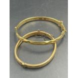 Two 9ct gold bangles with metal core (Approximate Total weight 18.5g)