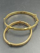 Two 9ct gold bangles with metal core (Approximate Total weight 18.5g)